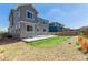 Backyard featuring a stone area, small lawn, and a concrete patio perfect for outdoor entertaining at 12941 Delaware St, Westminster, CO 80234