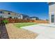 A backyard with a stone area, small lawn, concrete patio and wood fence creating a cozy outdoor space at 12941 Delaware St, Westminster, CO 80234