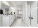 Spa-like bathroom featuring double vanity, shower, and bedroom view enhancing the home's appeal at 12941 Delaware St, Westminster, CO 80234