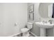 Elegant powder room features a pedestal sink, modern fixtures, and contemporary wall decor at 12941 Delaware St, Westminster, CO 80234