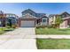 Inviting two-story home boasting a brick facade, attached garage, and manicured lawn at 12941 Delaware St, Westminster, CO 80234