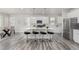 Modern kitchen featuring an island with bar seating, stainless steel appliances, and white cabinets at 12941 Delaware St, Westminster, CO 80234