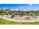 Community playground featuring modern play structures, woodchip ground cover, and well-maintained landscaping at 12941 Delaware St, Westminster, CO 80234