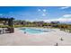 A spacious community pool with pergolas, lounge chairs, and neighborhood houses in the background at 12941 Delaware St, Westminster, CO 80234