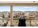 Tranquil back deck view overlooking fenced yards with mountain views in the distance at 6143 Eldora St, Golden, CO 80403