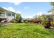Spacious backyard featuring lush green grass, mature trees, and a privacy fence, perfect for outdoor activities at 6143 Eldora St, Golden, CO 80403