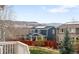 Fenced backyard view from deck, showcasing landscaping, privacy and mountain views in the distance at 6143 Eldora St, Golden, CO 80403