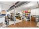 Well-lit basement with hardwood floors, metal beams and organized storage solutions at 6143 Eldora St, Golden, CO 80403