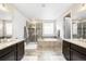 Bright bathroom features a soaking tub, glass shower, and double vanity with granite countertops at 6143 Eldora St, Golden, CO 80403