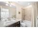 Bright bathroom with a granite-style counter, tiled shower, and access to the bedroom at 6143 Eldora St, Golden, CO 80403
