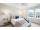 Sunny bedroom features a queen bed, side tables, and ample natural light from the windows at 6143 Eldora St, Golden, CO 80403