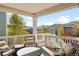 Comfortable covered deck with outdoor seating, perfect for enjoying scenic views of the neighborhood at 6143 Eldora St, Golden, CO 80403