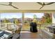 Relaxing covered deck featuring ceiling fans, cozy seating, and a grill, great for outdoor cooking and gatherings at 6143 Eldora St, Golden, CO 80403