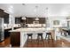 Modern kitchen featuring a large center island, stainless steel appliances, and dark cabinetry, perfect for culinary enthusiasts at 6143 Eldora St, Golden, CO 80403