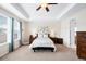 Bright main bedroom featuring a tray ceiling, art, and a comfortable queen bed at 6143 Eldora St, Golden, CO 80403