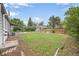 A spacious backyard with green grass, a patio, a shed, and a wooden fence at 1801 S Eudora St, Denver, CO 80222