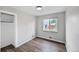 The bedroom showcases a neutral color scheme, wood floors, and a window with natural light at 1801 S Eudora St, Denver, CO 80222