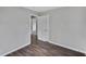 Clean bedroom with hardwood floors, neutral paint, closet, and adjoining space at 1801 S Eudora St, Denver, CO 80222