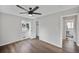 Well-lit bedroom with hardwood floors, closet, and a view of the outdoors at 1801 S Eudora St, Denver, CO 80222