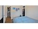 Bedroom featuring a door to a walk-in closet and posters on the light gray walls at 1801 S Eudora St, Denver, CO 80222
