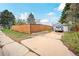 Long driveway leading to a detached garage and a tall wooden fence for privacy at 1801 S Eudora St, Denver, CO 80222