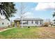 Charming single-story home with a well-maintained front yard and yellow door at 1801 S Eudora St, Denver, CO 80222