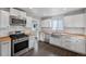 Bright kitchen featuring white cabinets, stainless steel appliances, and butcher block countertops at 1801 S Eudora St, Denver, CO 80222