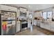 Modern kitchen with stainless steel appliances, white cabinets, and stylish butcher block countertops at 1801 S Eudora St, Denver, CO 80222