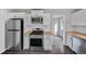 Well-lit kitchen boasts stainless steel appliances, wooden countertops, and ample cabinet space at 1801 S Eudora St, Denver, CO 80222