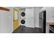 This laundry area includes a stacked washer and dryer set next to white cabinets at 1801 S Eudora St, Denver, CO 80222