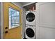 Laundry room with stacked washer/dryer next to the yellow backdoor at 1801 S Eudora St, Denver, CO 80222
