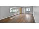 Large living room with hardwood floors, a bright yellow front door, and abundant natural light at 1801 S Eudora St, Denver, CO 80222