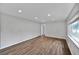 Bright and airy living room with hardwood floors, recessed lighting, and large windows at 1801 S Eudora St, Denver, CO 80222