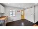 This mudroom features a stylish yellow door, white cabinets and dark-colored flooring at 1801 S Eudora St, Denver, CO 80222