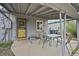 Covered patio with seating, a gray exterior, and a yellow screen door at 1801 S Eudora St, Denver, CO 80222