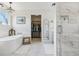 Elegant bathroom showcasing a soaking tub, walk-in shower, and a well-organized closet at 10570 Humboldt Peak Way, Parker, CO 80138