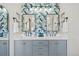 Stylish bathroom with double vanity, quartz countertops, and designer wallpaper at 10570 Humboldt Peak Way, Parker, CO 80138