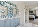 Stylish bathroom with double vanity, quartz countertops, and striking floral wallpaper at 10570 Humboldt Peak Way, Parker, CO 80138