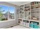 Bedroom featuring built-in bookshelves and a bright window with neighborhood view at 10570 Humboldt Peak Way, Parker, CO 80138