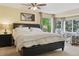 Bright bedroom with a large window, patterned armchairs, and a comfortable bed with under-bed storage drawers at 10570 Humboldt Peak Way, Parker, CO 80138