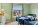 Bedroom with two beds, a window with a view of a house and neutral wall and floor coverings at 10570 Humboldt Peak Way, Parker, CO 80138