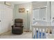 Comfortable Bedroom with a recliner, crib, and a window with natural light at 10570 Humboldt Peak Way, Parker, CO 80138