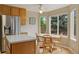 Bright dining area with wood table, chairs, and large windows with natural light at 10570 Humboldt Peak Way, Parker, CO 80138