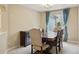 Dining room with a wooden table and chairs set and blue curtains by the window at 10570 Humboldt Peak Way, Parker, CO 80138