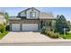 Charming two-story home featuring a stone facade, a two-car garage, and a welcoming front porch at 10570 Humboldt Peak Way, Parker, CO 80138