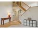 Inviting foyer with a wooden staircase, console table, and decorative accents, creating a warm entrance at 10570 Humboldt Peak Way, Parker, CO 80138