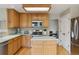 Bright kitchen with wood cabinets, stainless steel appliances, and center island, ideal for cooking at 10570 Humboldt Peak Way, Parker, CO 80138