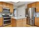 Modern kitchen with stainless steel appliances and a center island with hardwood floors at 10570 Humboldt Peak Way, Parker, CO 80138