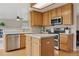 Modern kitchen with stainless steel appliances, hardwood floors, and a center island at 10570 Humboldt Peak Way, Parker, CO 80138