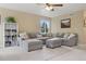 Bright living room with a comfortable gray sectional sofa and stylish decorations at 10570 Humboldt Peak Way, Parker, CO 80138